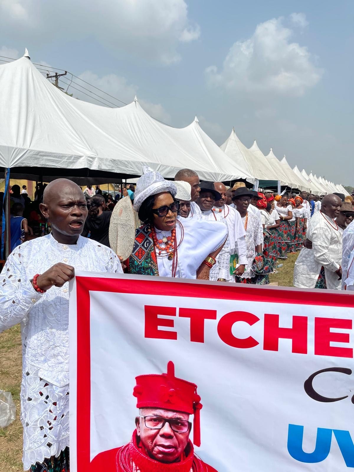 A delegation processing in white with red coral beads.